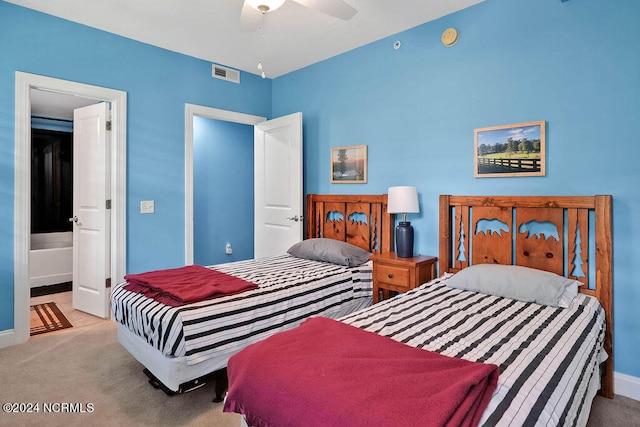 bedroom featuring ensuite bath, ceiling fan, and light colored carpet