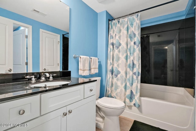 full bathroom with shower / tub combo with curtain, vanity, toilet, and tile patterned floors