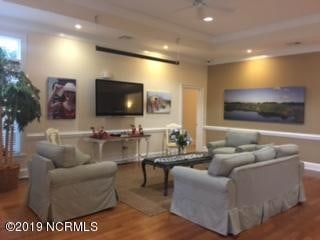 living room with hardwood / wood-style flooring and ceiling fan