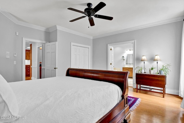 bedroom featuring a closet, light hardwood / wood-style floors, ensuite bath, ornamental molding, and ceiling fan