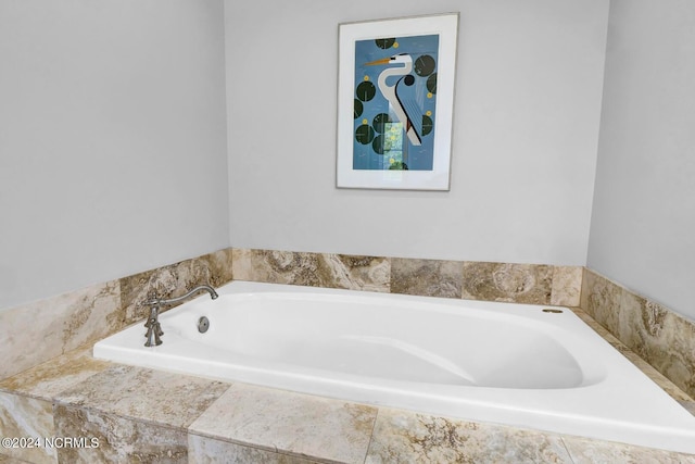 bathroom with a relaxing tiled tub