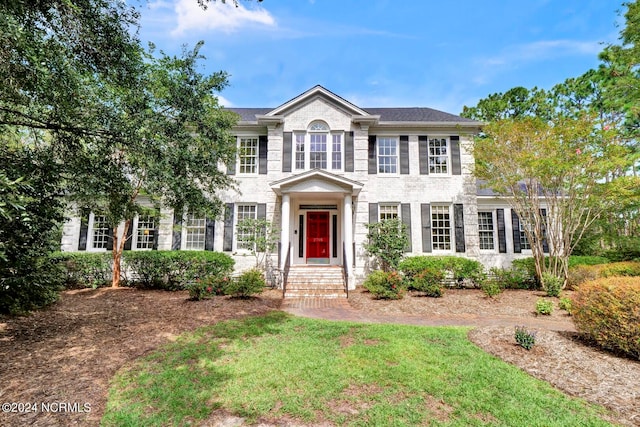 colonial home with a front yard