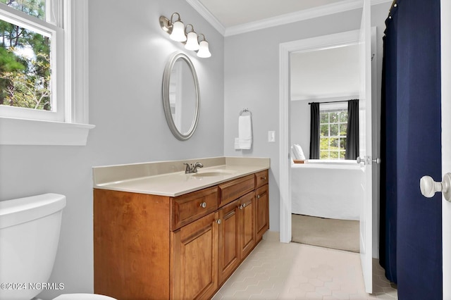 bathroom featuring tile patterned flooring, toilet, crown molding, and vanity