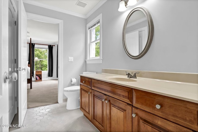 bathroom featuring tile patterned flooring, vanity, toilet, and crown molding