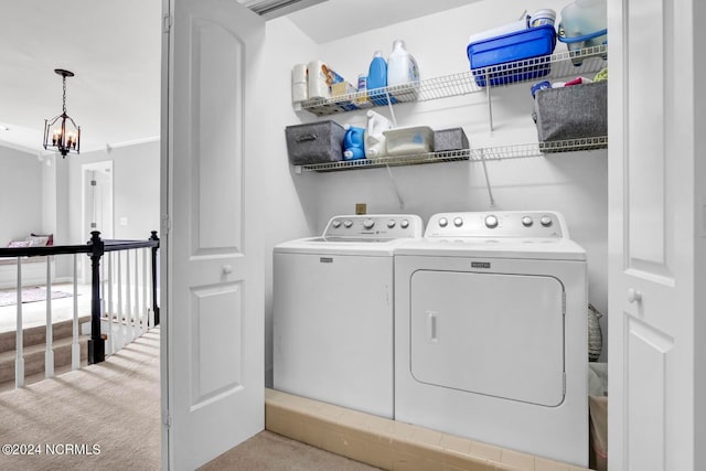 laundry room featuring light carpet, ornamental molding, separate washer and dryer, and a notable chandelier