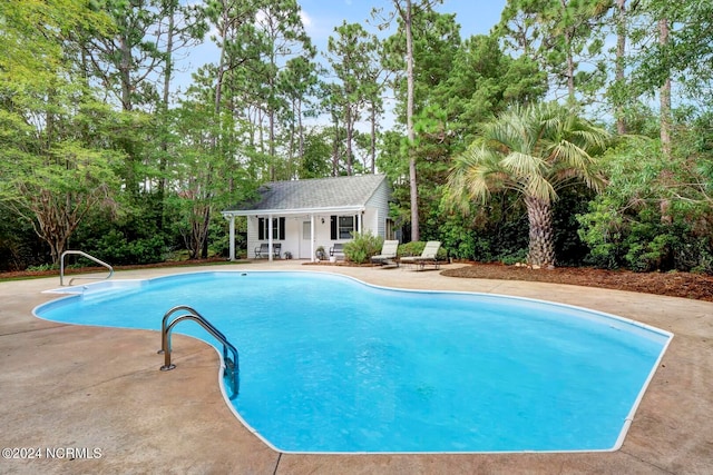 view of pool featuring a patio area and an outdoor structure