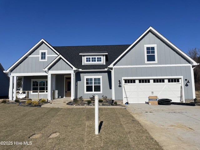 craftsman-style home with covered porch and a garage