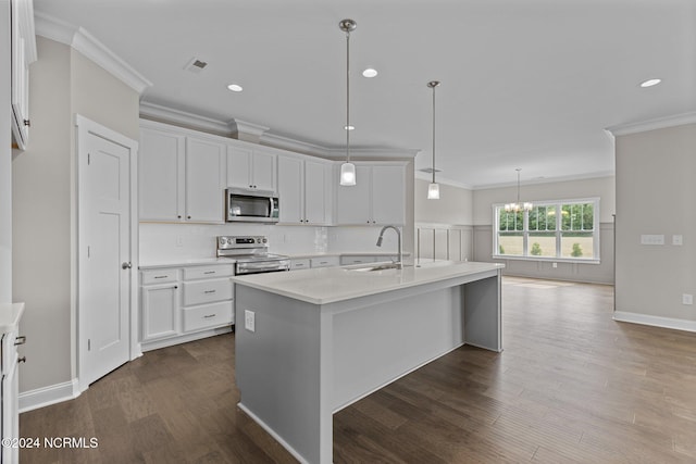 kitchen with a center island with sink, a premium fireplace, hanging light fixtures, stainless steel dishwasher, and sink