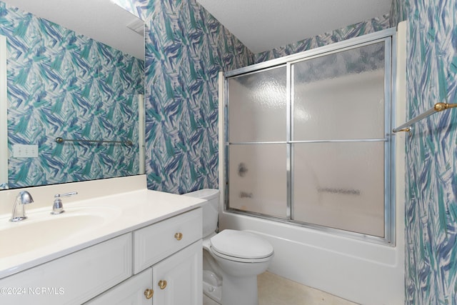 full bathroom with combined bath / shower with glass door, a textured ceiling, vanity, and toilet