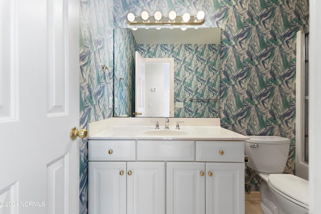 bathroom featuring toilet and vanity