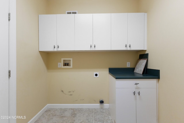 laundry area featuring washer hookup, electric dryer hookup, light tile patterned floors, and cabinets