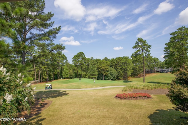 view of home's community featuring a yard and golf course view