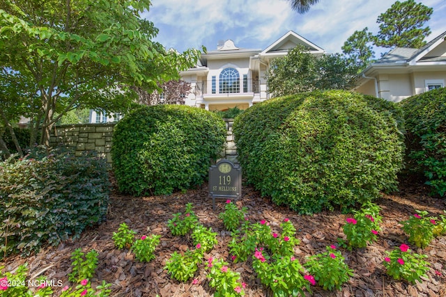 view of front of property featuring stone siding and stucco siding