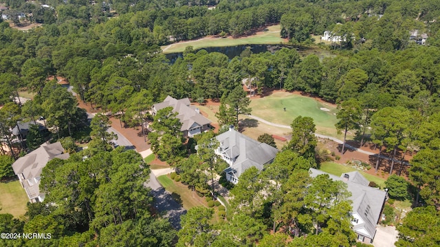 bird's eye view featuring golf course view and a wooded view