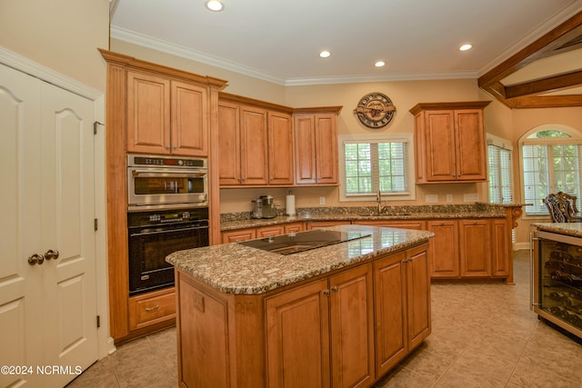 kitchen featuring double oven, a center island, plenty of natural light, and black electric cooktop