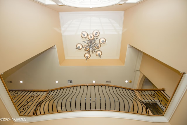 stairway featuring an inviting chandelier and visible vents