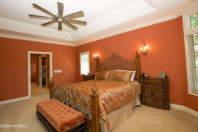 bedroom with carpet floors, a tray ceiling, crown molding, and baseboards