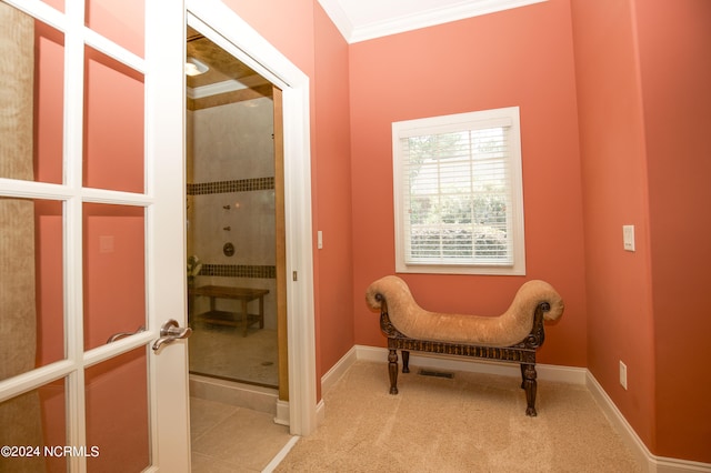 sitting room featuring ornamental molding, carpet, and baseboards