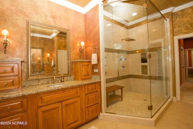 bathroom featuring a stall shower, tile patterned flooring, vanity, and crown molding