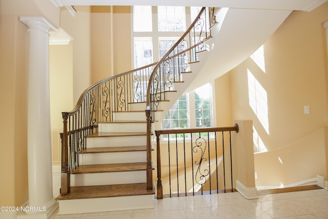 119 Saint Mellions Dr, Pinehurst, NC 28374 - staircase featuring tile patterned floors, a towering ceiling, and baseboards