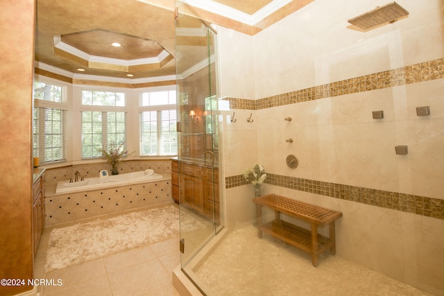 full bathroom featuring a tray ceiling, a garden tub, ornamental molding, a shower stall, and tile patterned floors