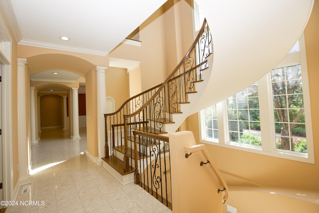 stairs featuring arched walkways, recessed lighting, ornamental molding, tile patterned flooring, and ornate columns