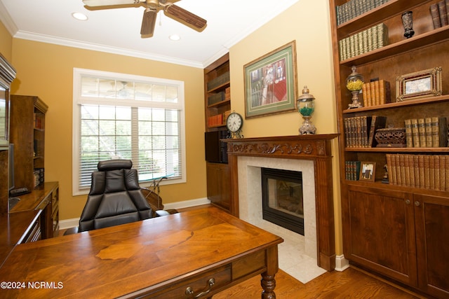 119 Saint Mellions Dr, Pinehurst, NC 28374 - office area with crown molding, built in shelves, a ceiling fan, and a high end fireplace