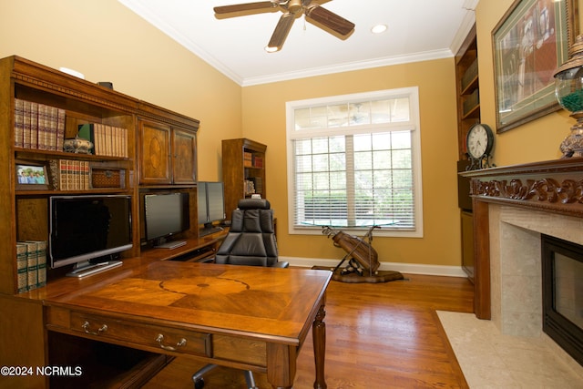 119 Saint Mellions Dr, Pinehurst, NC 28374 - home office with crown molding, a ceiling fan, wood finished floors, a tiled fireplace, and baseboards