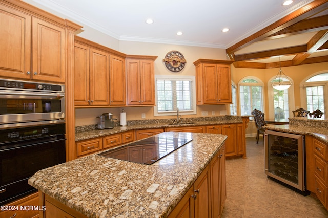 kitchen featuring plenty of natural light, beverage cooler, a kitchen island, black electric cooktop, and a sink