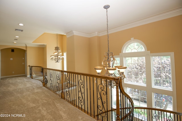 hallway with recessed lighting, carpet floors, visible vents, ornamental molding, and an inviting chandelier