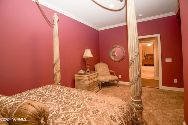 carpeted bedroom with ornamental molding and baseboards