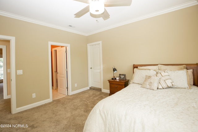 bedroom featuring baseboards, visible vents, ceiling fan, carpet, and crown molding