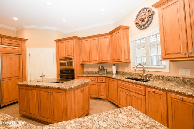 kitchen featuring light tile patterned floors, paneled built in refrigerator, black electric cooktop, crown molding, and a sink