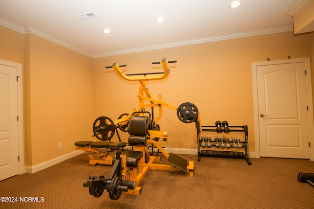 workout area featuring baseboards, visible vents, and crown molding