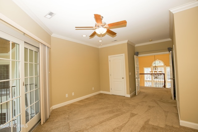 unfurnished room featuring crown molding, carpet, visible vents, and baseboards