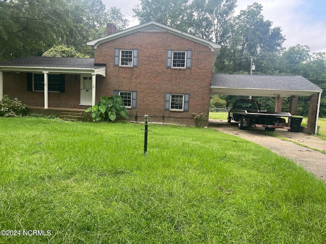 split level home featuring a front yard and brick siding