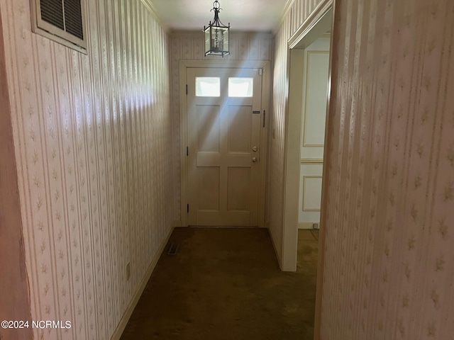 doorway featuring baseboards, carpet floors, visible vents, and wallpapered walls