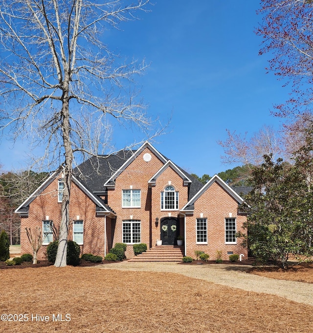 traditional-style home featuring brick siding