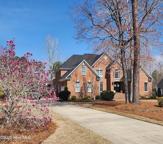 traditional home with brick siding and concrete driveway