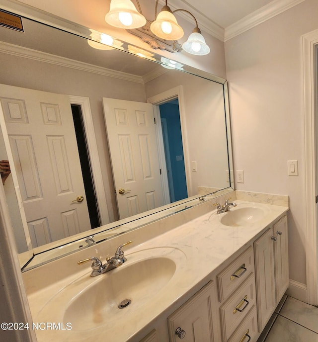 full bathroom with double vanity, tile patterned floors, crown molding, and a sink