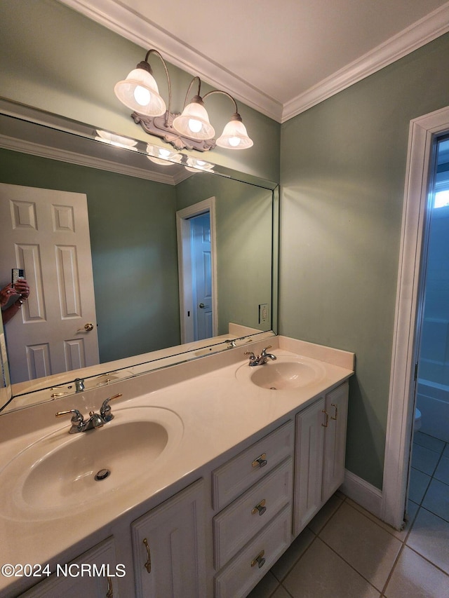 full bath featuring tile patterned floors, ornamental molding, double vanity, and a sink