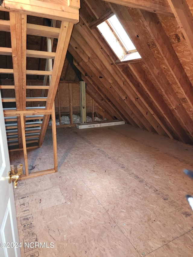 unfinished attic with a skylight