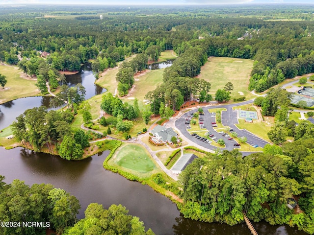 drone / aerial view featuring a water view and a view of trees