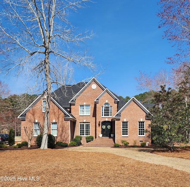 traditional-style house featuring brick siding