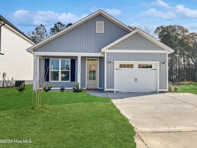 view of front of home with board and batten siding, a front yard, central AC, and an attached garage