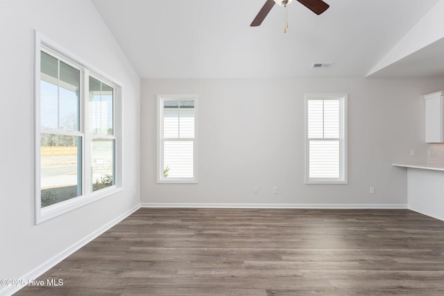 unfurnished living room with vaulted ceiling, dark hardwood / wood-style floors, and ceiling fan