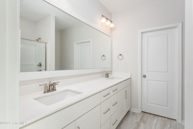 bathroom with vanity and an enclosed shower