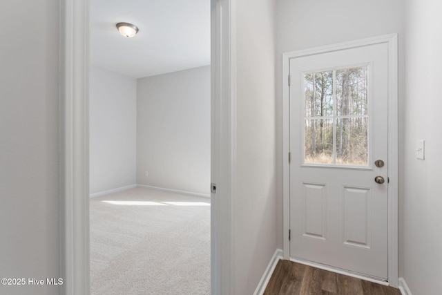 doorway to outside with dark carpet