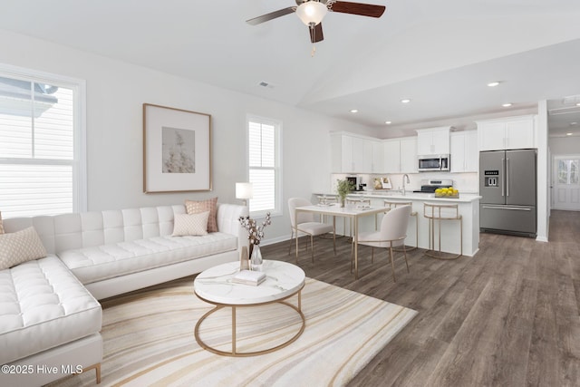 living area featuring visible vents, a ceiling fan, lofted ceiling, wood finished floors, and recessed lighting