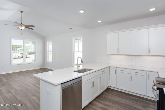 kitchen with stainless steel appliances, sink, white cabinets, and kitchen peninsula